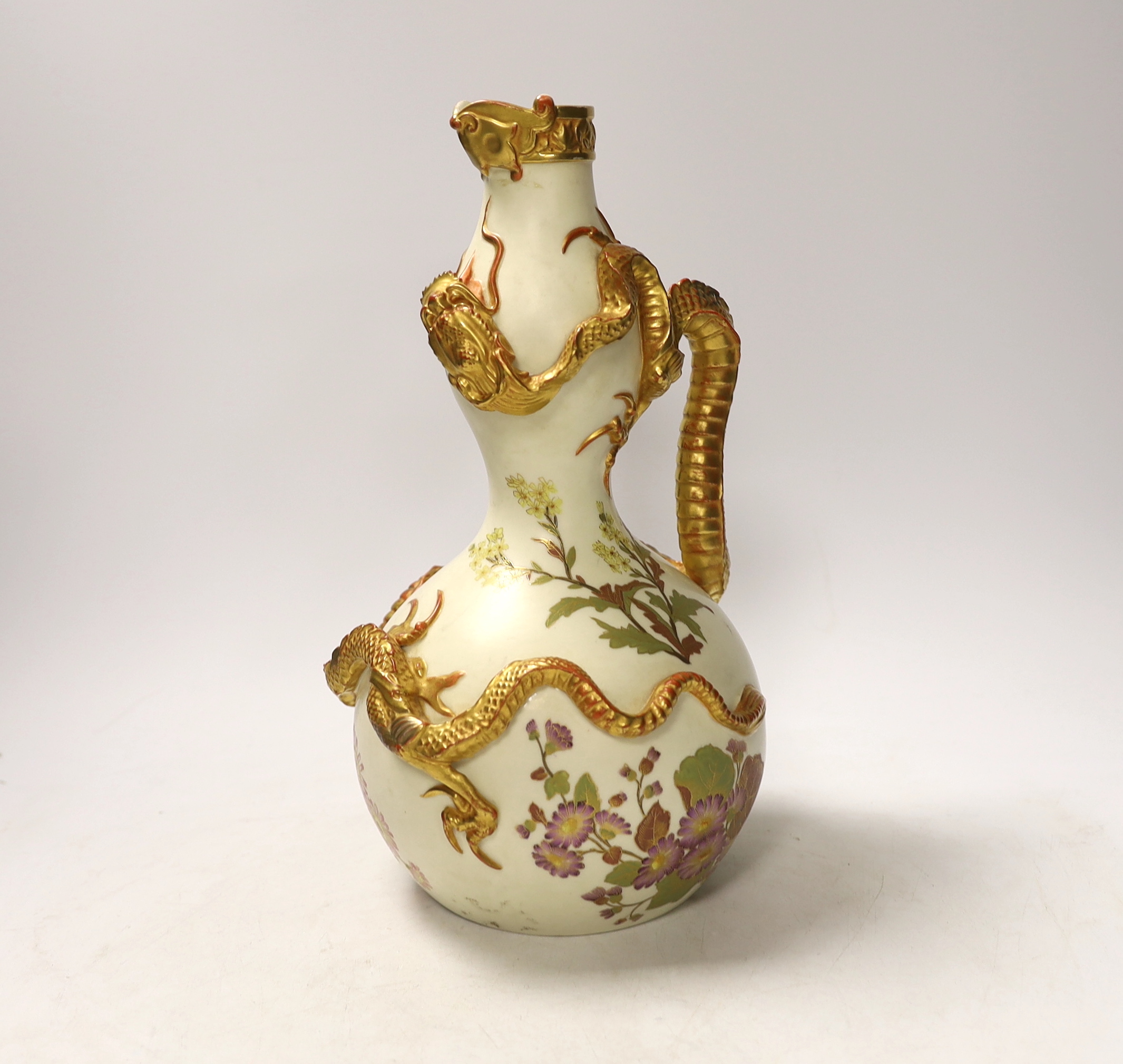 A Royal Worcester ewer with dragon handle, numbered 1035, 29cm high